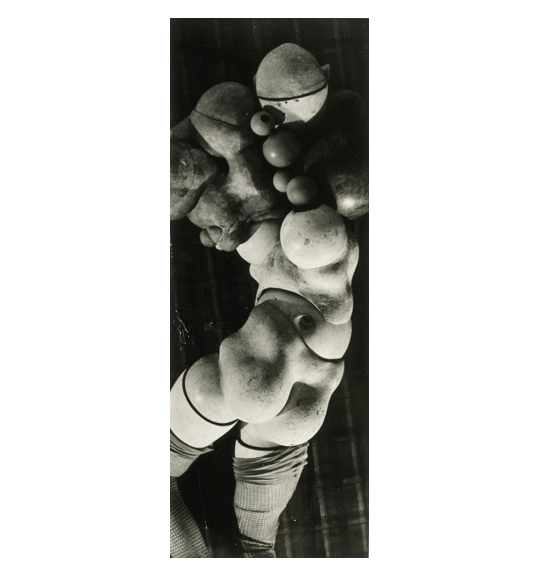 A photograph of what appears to be a mannequin wearing high socks. It appears be made of various ball like shapes.